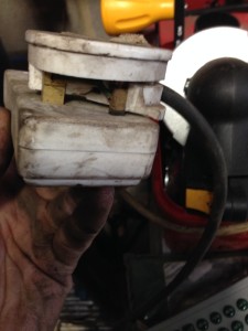 A Damaged plug still in use at your local Garage