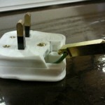 A damaged plug for a laminator still in use in a doctors surgery